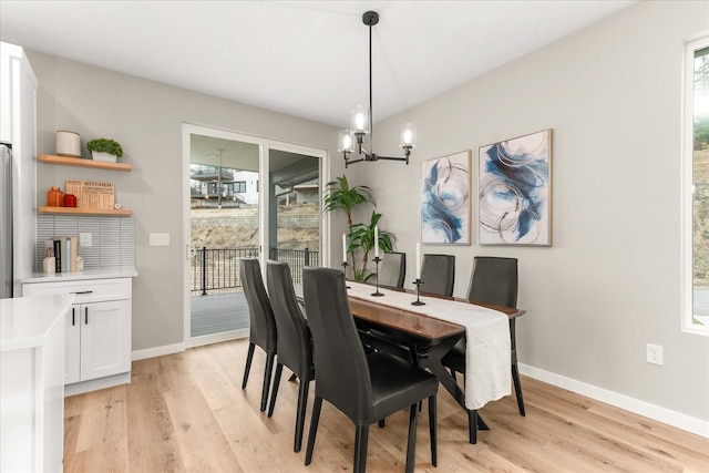 4243 W Tolliver Ct, Spokane, WA 99208 - dining room with light wood finished floors, a chandelier, and baseboards
