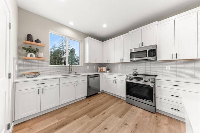 4243 W Tolliver Ct, Spokane, WA 99208 - kitchen with stainless steel appliances, a sink, open shelves, light countertops, and recessed lighting