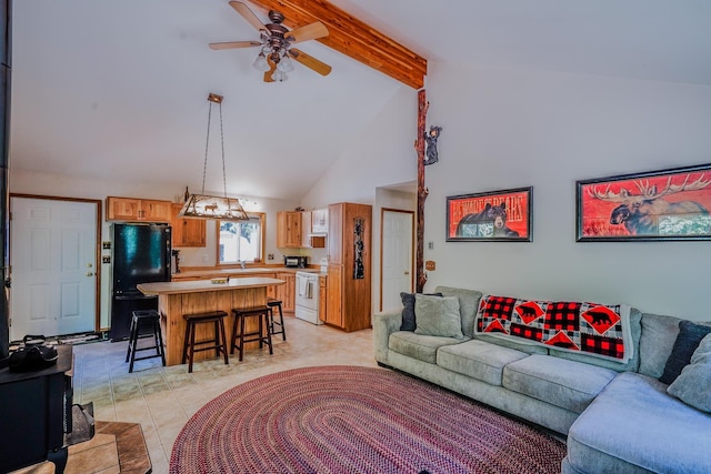 living area with a ceiling fan, beamed ceiling, and high vaulted ceiling