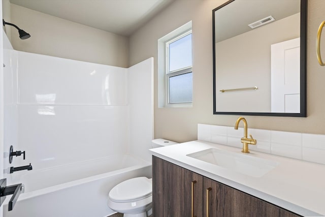 923 E Everett Avenue 921E Everett Ave, Spokane, WA 99212 - full bathroom featuring decorative backsplash, toilet,  shower combination, and vanity