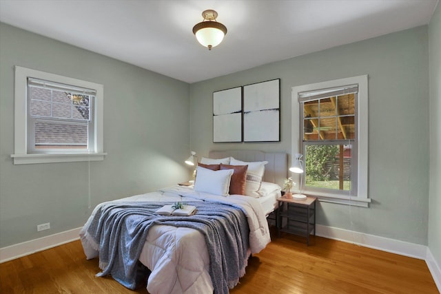 1308 W 11th Ave, Spokane, WA 99204 - bedroom featuring multiple windows, wood finished floors, and baseboards