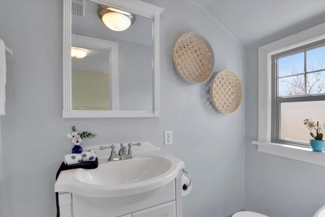 1308 W 11th Ave, Spokane, WA 99204 - bathroom featuring vanity, vaulted ceiling, and toilet