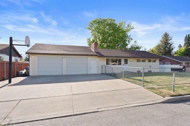 single story home with a chimney, an attached garage, and concrete driveway