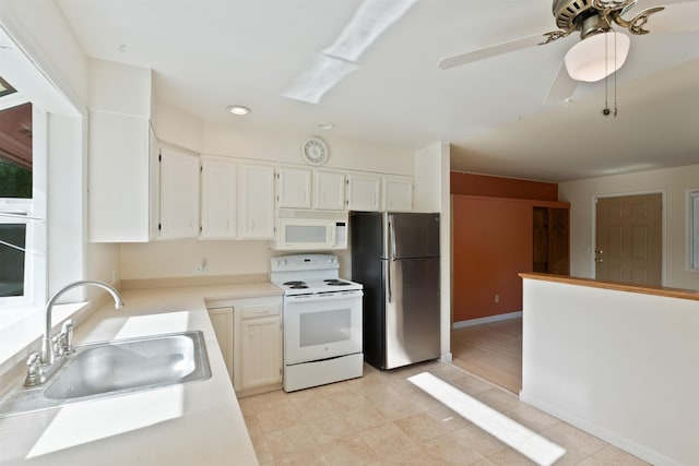kitchen with white appliances, a sink, a ceiling fan, light countertops, and recessed lighting