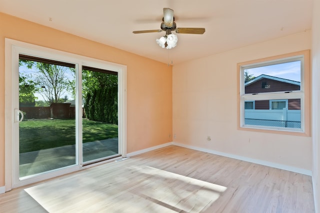 empty room featuring light wood-type flooring, baseboards, and ceiling fan