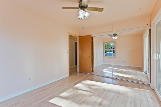 unfurnished room featuring wood finished floors, baseboards, and a ceiling fan