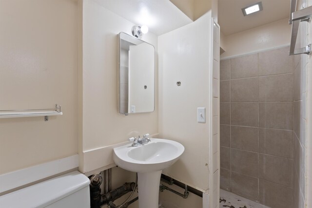 bathroom with toilet and a stall shower