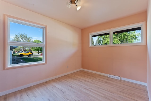 spare room featuring wood finished floors and baseboards