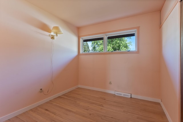 unfurnished room with light wood-style floors and baseboards