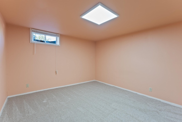 empty room featuring carpet and baseboards