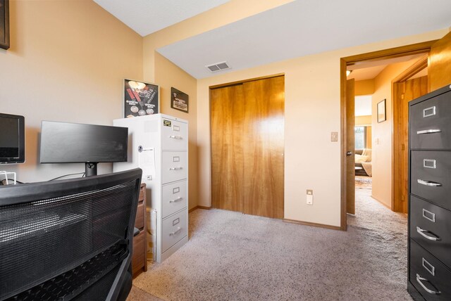 carpeted home office featuring baseboards