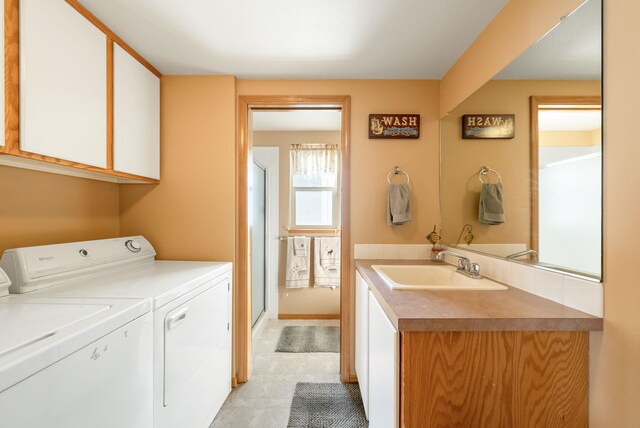 laundry area with washer and clothes dryer and cabinet space