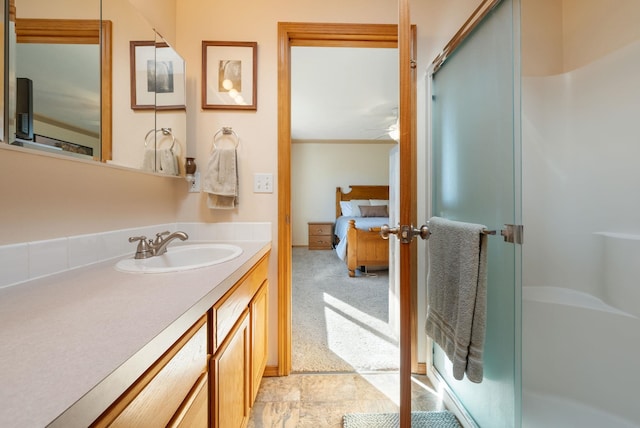 full bathroom with a stall shower, vanity, and a ceiling fan