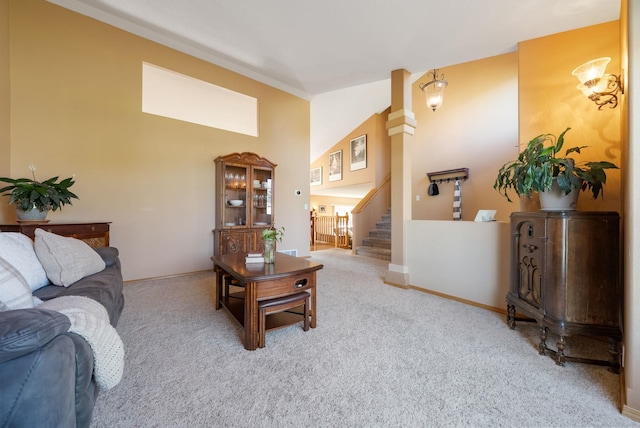 living room with carpet, stairs, and high vaulted ceiling