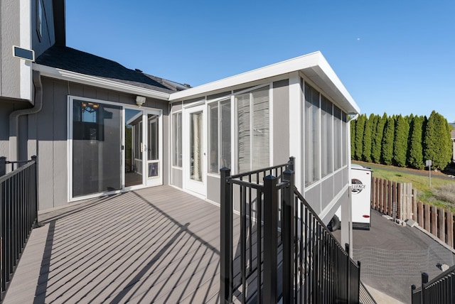 wooden deck with a sunroom and agricultural area