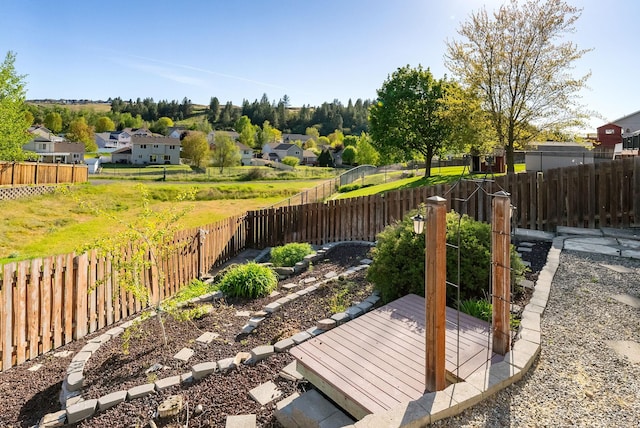 fenced backyard featuring a residential view and a deck