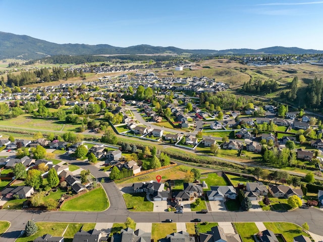 aerial view of property and surrounding area with mountains and nearby suburban area