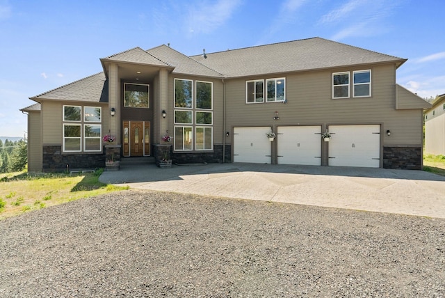 18707 E Terrapin Ln, Otis Orchards, WA 99027 - view of front of house with driveway, a garage, stone siding, and a shingled roof