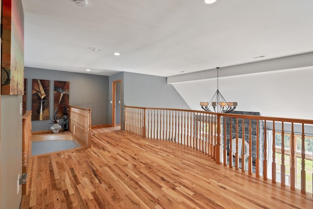 18707 E Terrapin Ln, Otis Orchards, WA 99027 - corridor with wood finished floors, a chandelier, recessed lighting, and baseboards
