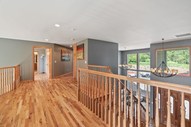 18707 E Terrapin Ln, Otis Orchards, WA 99027 - corridor with a chandelier, an upstairs landing, recessed lighting, light wood-style flooring, and baseboards