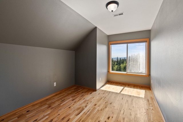 18707 E Terrapin Ln, Otis Orchards, WA 99027 - additional living space featuring wood finished floors, vaulted ceiling, and baseboards