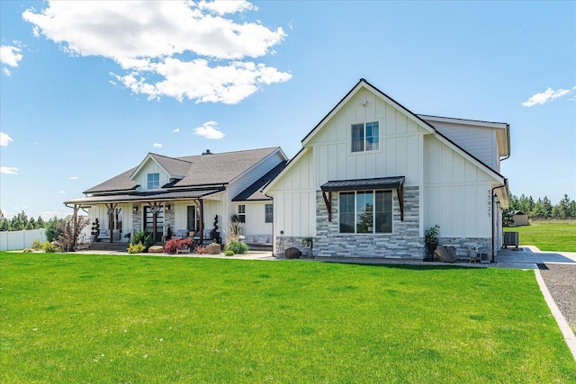 15921 W Four Mound Rd, Nine Mile Falls, WA 99026 - rear view of house featuring board and batten siding, covered porch, and stone siding