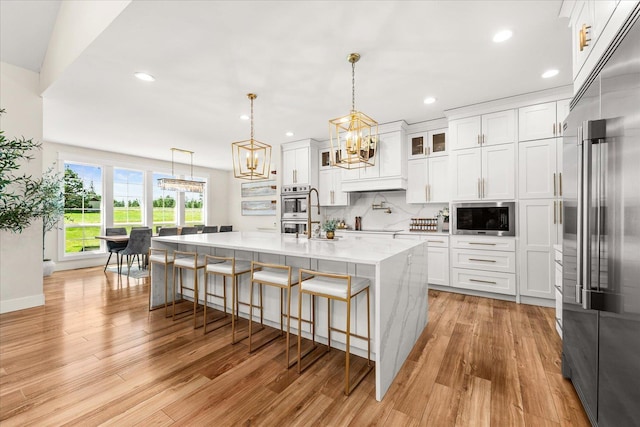15921 W Four Mound Rd, Nine Mile Falls, WA 99026 - dining space with baseboards, light wood-style floors, and a chandelier