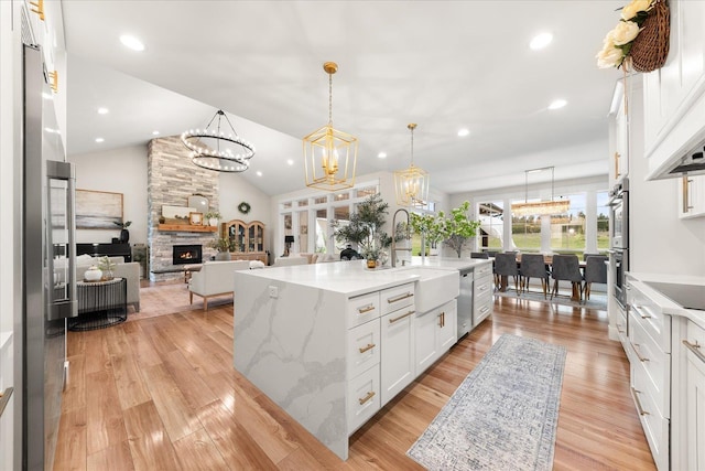 15921 W Four Mound Rd, Nine Mile Falls, WA 99026 - kitchen featuring stainless steel appliances, white cabinets, decorative backsplash, recessed lighting, and light wood finished floors