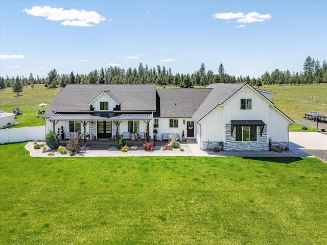 15921 W Four Mound Rd, Nine Mile Falls, WA 99026 - back of property with board and batten siding, a patio area, french doors, and a pergola