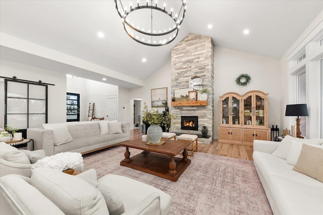 15921 W Four Mound Rd, Nine Mile Falls, WA 99026 - living area with high vaulted ceiling, a fireplace, light wood-style floors, a chandelier, and recessed lighting