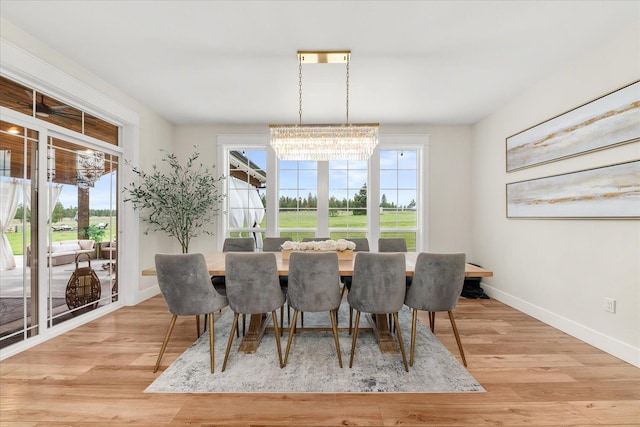 15921 W Four Mound Rd, Nine Mile Falls, WA 99026 - dining space with baseboards, light wood-style floors, and a chandelier