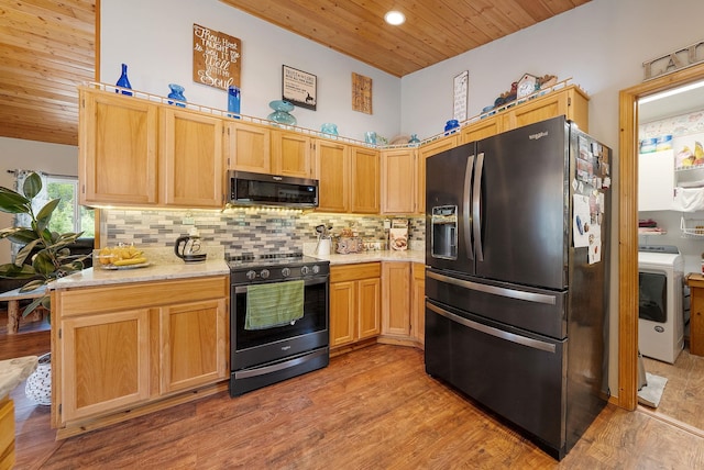 kitchen featuring refrigerator with ice dispenser, stainless steel microwave, black electric range oven, wood ceiling, and washer / dryer
