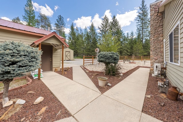 view of yard with a storage shed, fence, and an outdoor structure