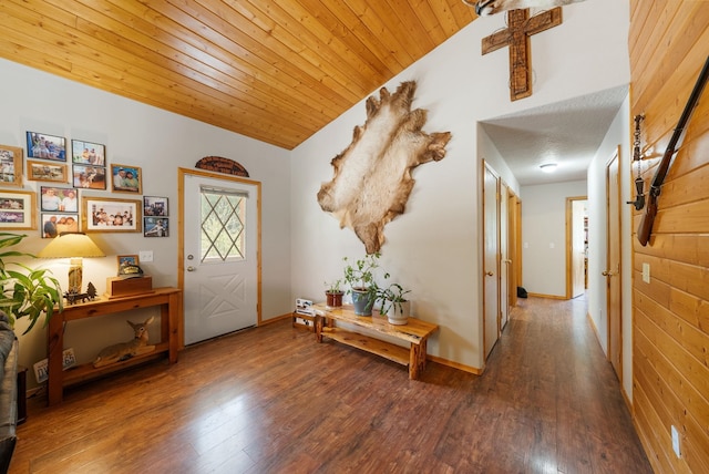 foyer entrance featuring hardwood / wood-style flooring, lofted ceiling, wooden ceiling, and baseboards