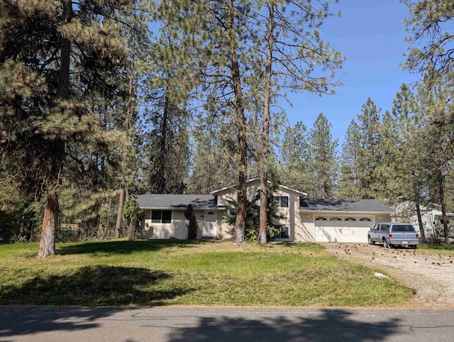 view of front of property with driveway, a front yard, and a garage