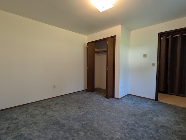 unfurnished bedroom featuring dark carpet and baseboards