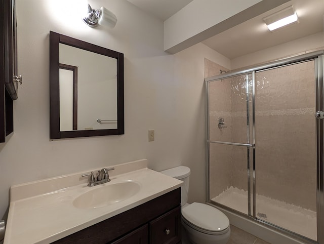 bathroom with toilet, a shower stall, and vanity