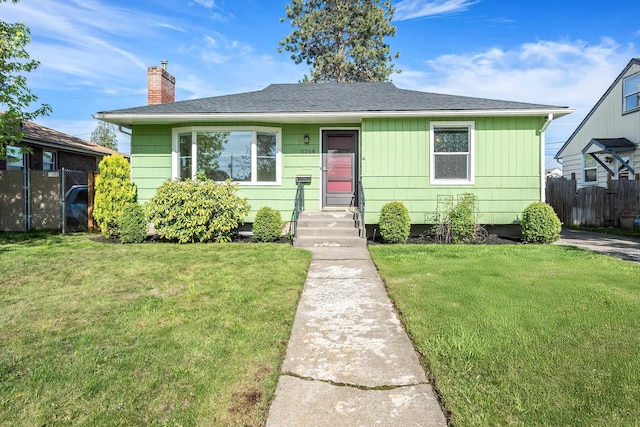 bungalow-style house featuring a chimney and roof with shingles