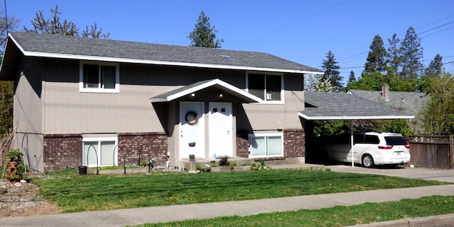 1222 S Pittsburg St Unit 1220, Spokane, WA 99223 - view of front facade with brick siding, a front lawn, concrete driveway, and an attached carport