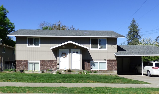 1222 S Pittsburg St Unit 1220, Spokane, WA 99223 - view of front of house featuring brick siding, a front lawn, a shingled roof, and a carport