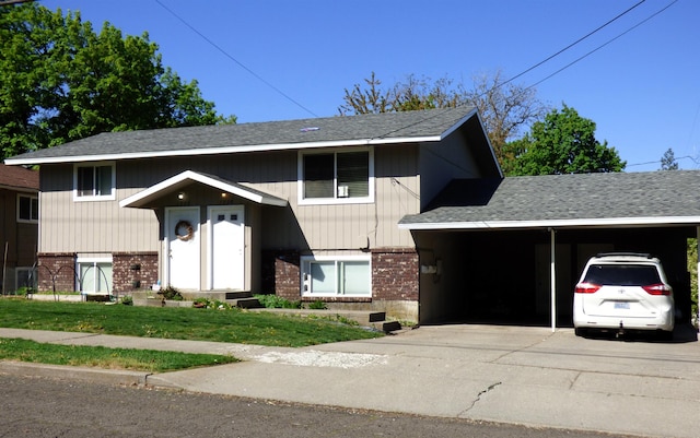 1222 S Pittsburg St Unit 1220, Spokane, WA 99223 - view of front facade with brick siding, roof with shingles, driveway, and a front lawn
