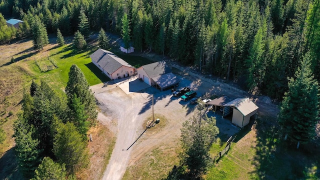 view from above of property with a heavily wooded area