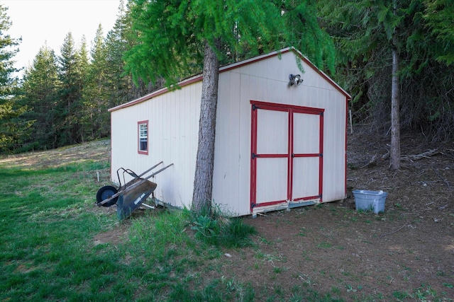 view of shed with a forest view
