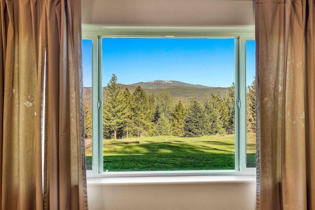doorway to outside with a mountain view and a view of trees