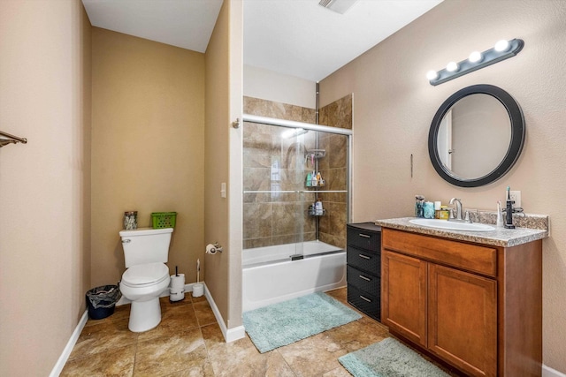 bathroom featuring toilet, vanity, shower / bath combination with glass door, and baseboards