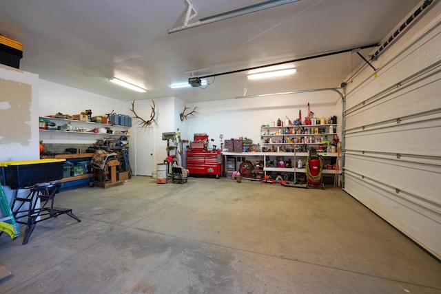 garage with a garage door opener and a workshop area