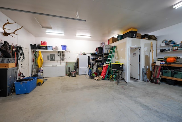 garage with freestanding refrigerator and a workshop area