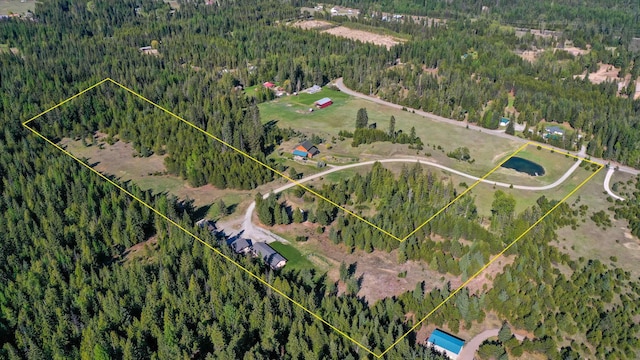 view of property location featuring a heavily wooded area and property boundaries highlighted