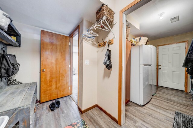 washroom with light wood-style floors and baseboards