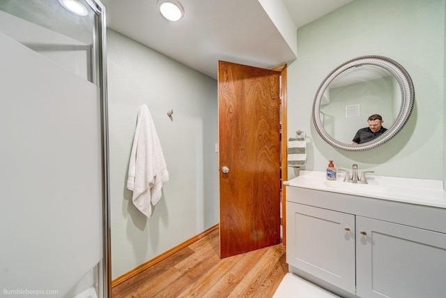 bathroom featuring wood finished floors and vanity